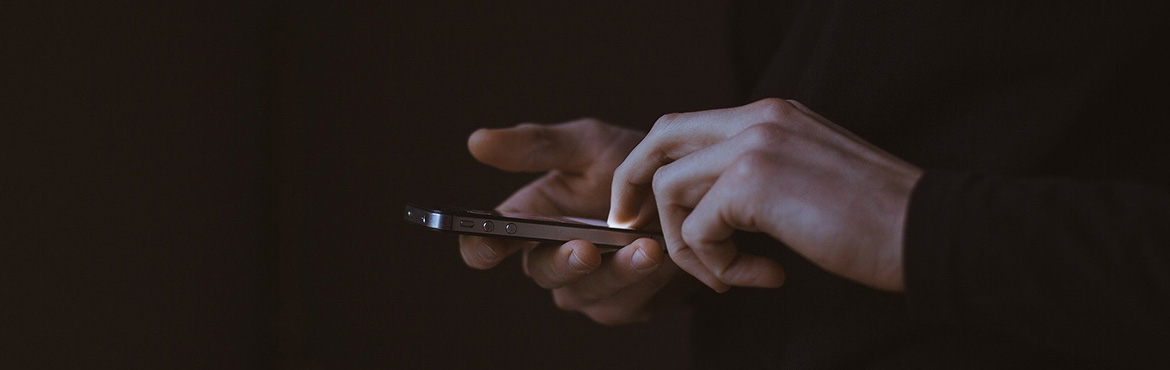 Hands using mobile phone