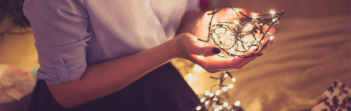 Woman holding Christmas lights