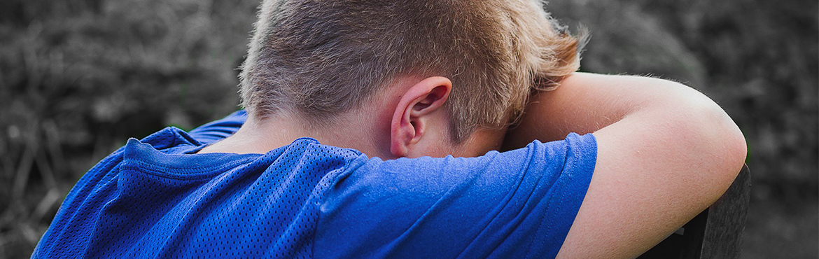 boy with head in hands