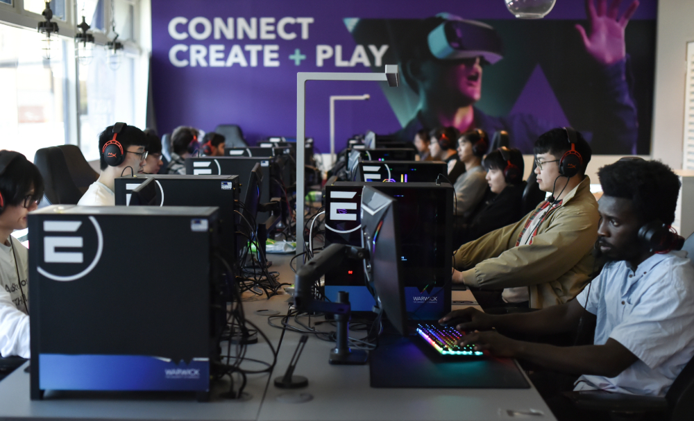a group of people sat in front of computers