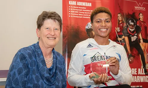 Kare Adenegan is presented with a special award recognising her achievements, by University of Warwick Provost, Professor Christine Ennew OBE