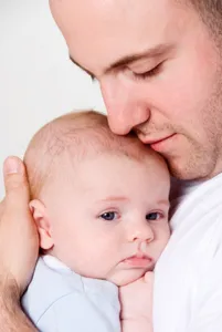 istock-_dad_cuddling_sad_baby.jpg