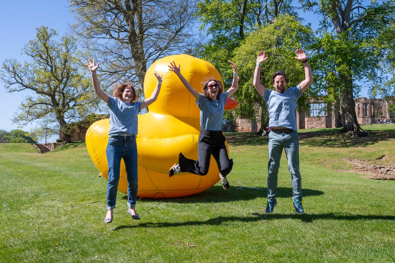 Ali Struthers (centre) in front of giant yellow duck with a School Tasking staff member ether side