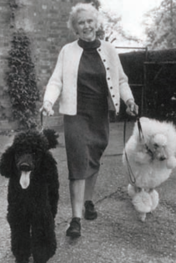 Photograph of Helen Martin in 1965 walking her two dogs