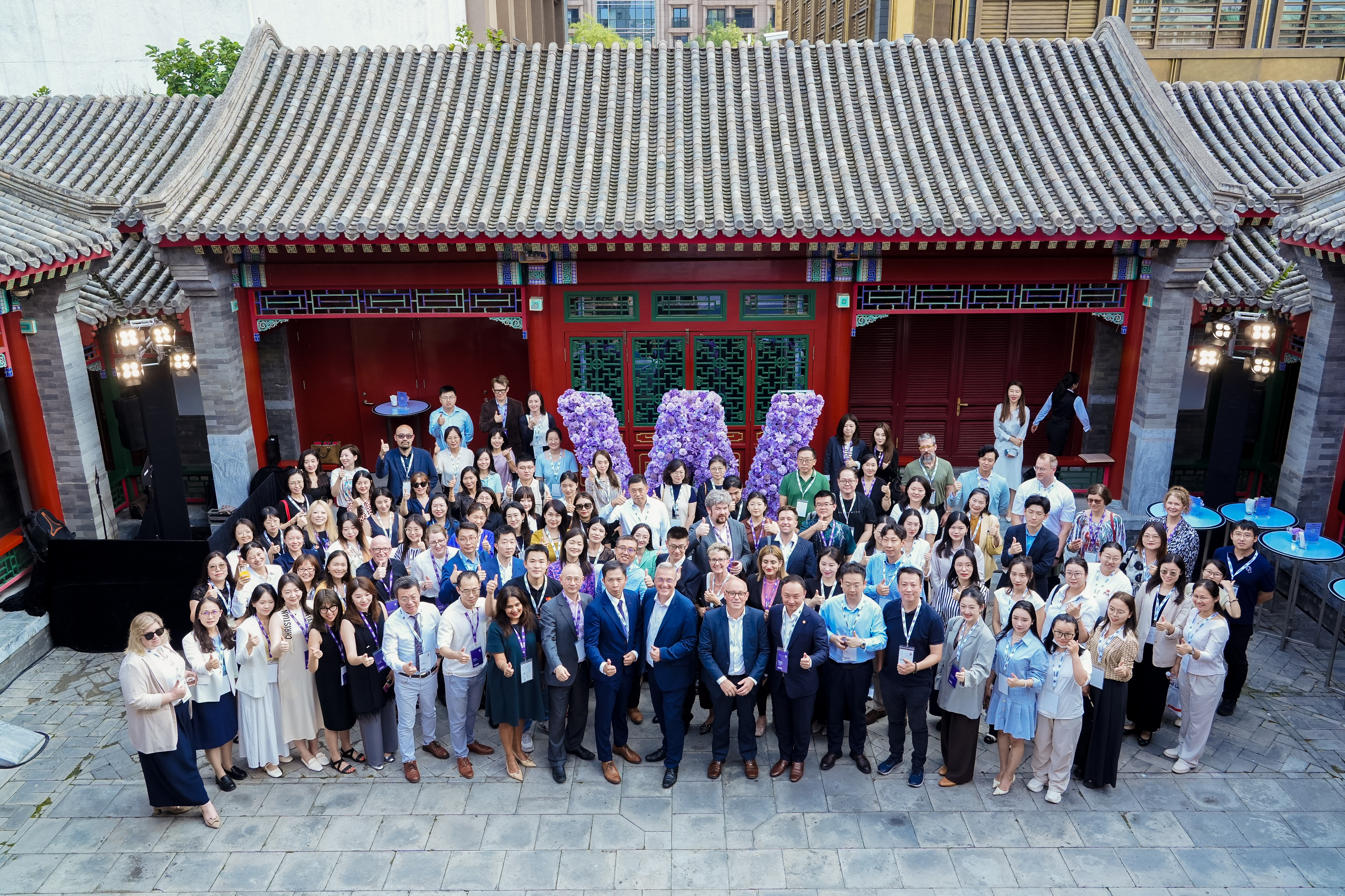 Group of alumni photo from above with Professor Stuart Croft, Vice-Chancellor at the centre. 