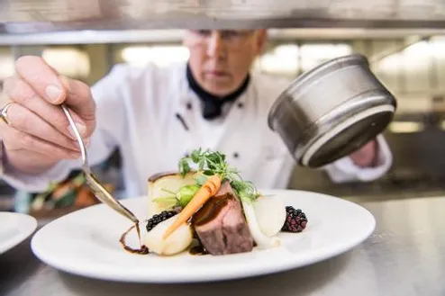 Chef preparing a plate of food