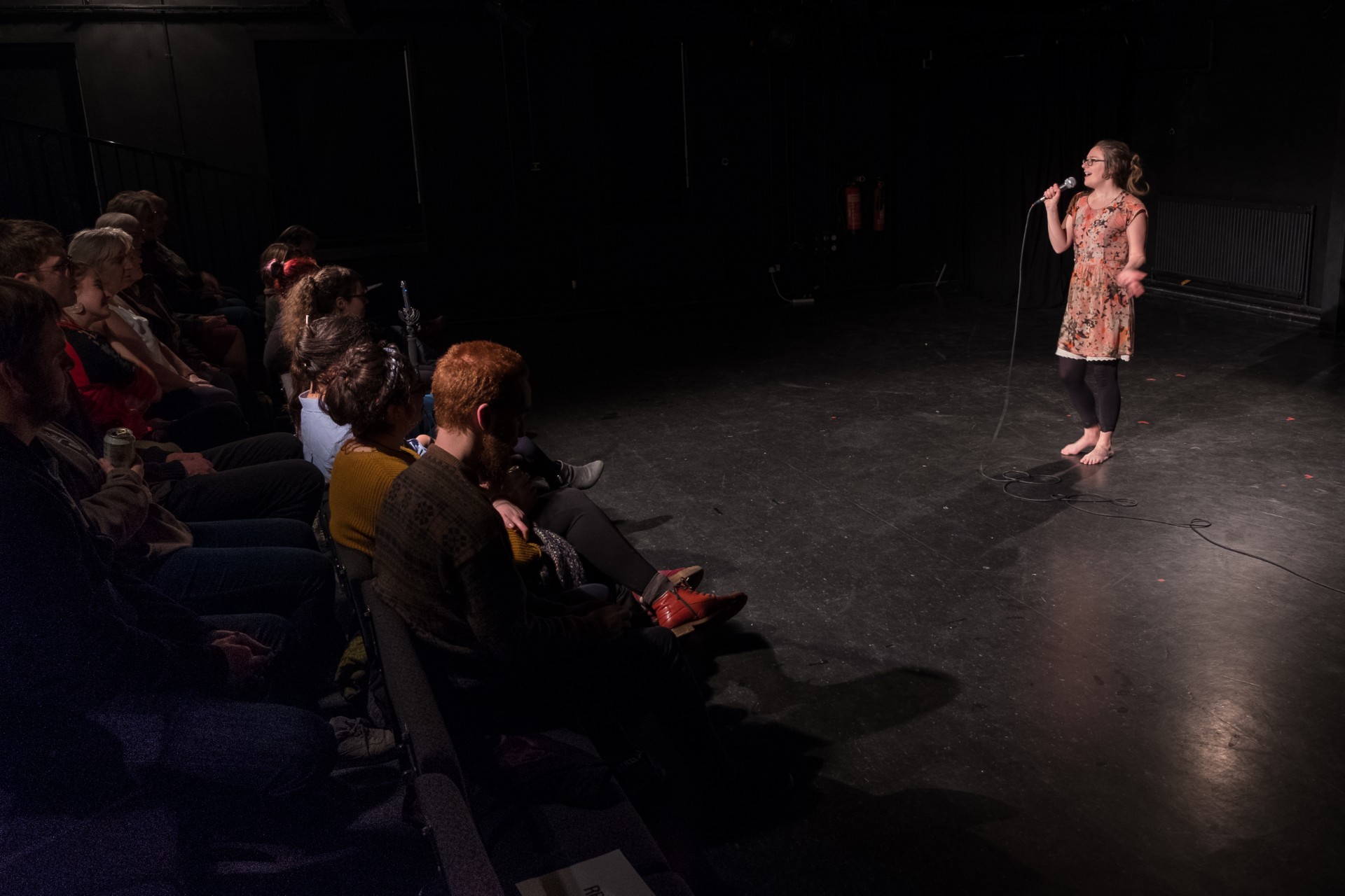 female stand up comic performing