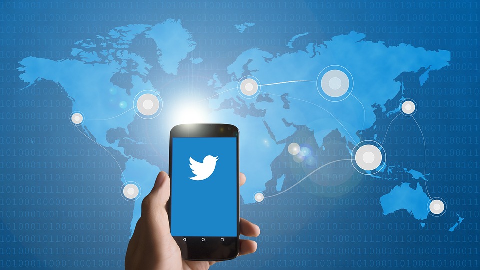 Hand holding phone with Twitter app open
