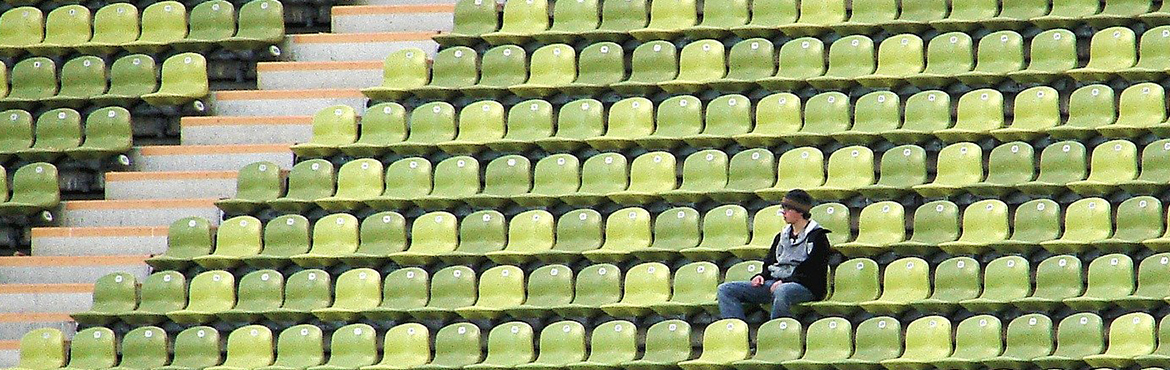 man in stadium on his own