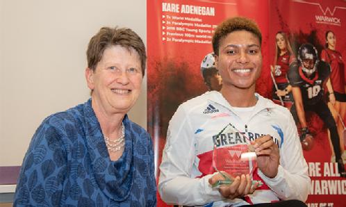 Kare Adenegan is presented with a special award recognising her achievements, by University of Warwick Provost, Professor Christine Ennew OBE
