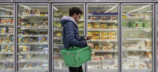 A man browsing convenience food in a supermarket