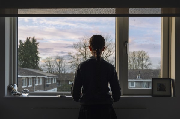 A young woman looking out a window