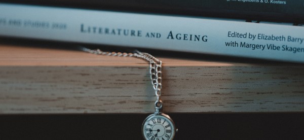 Professor Liz Barry's book on ageing alongside a pocketwatch