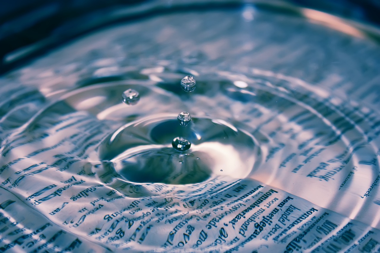 drop of water on a book with a ripple effect