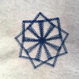 Blue cross-stitching on a white felt background. There are 9 pokes from the centre, and nine points around the outside.
