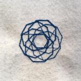 Blue stitching on a white felt fabric background. There are several overlapping octagons.