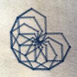 Blue stitching on a white felt fabric background. The stitch used is a cross stitch. The pattern is made of several hexagons overlapping each other to make three quarters of a circle. 