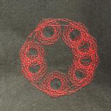 Red stitching on a black felt background. There are several loose circles joined together in a larger circular shape. 