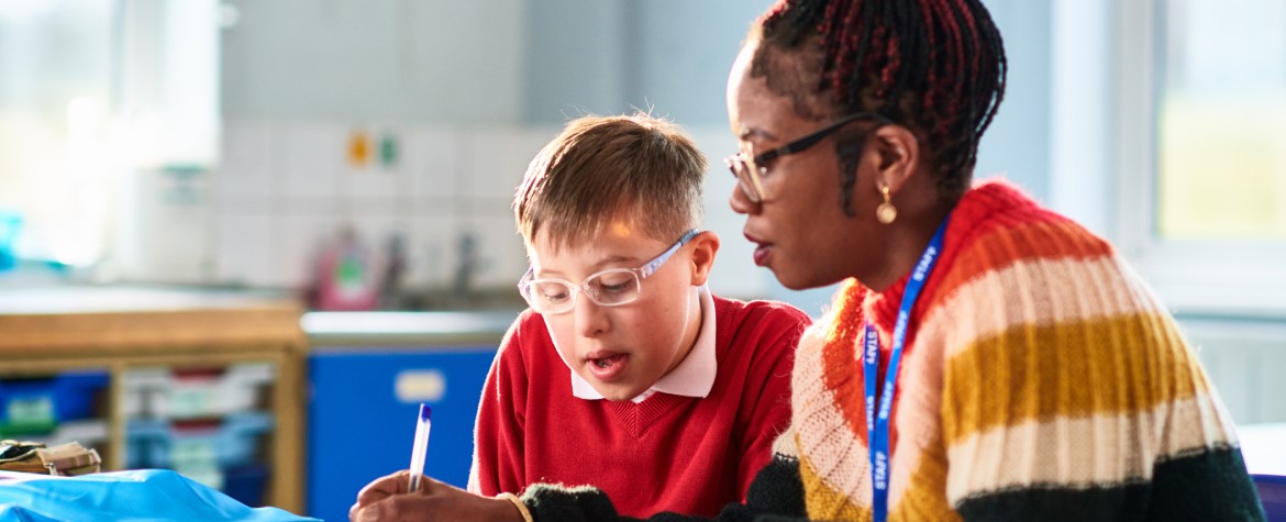 A black school teacher with a pupil