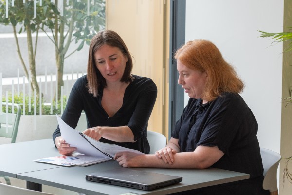 Two researchers looking at documents