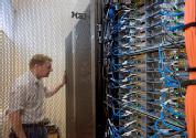 A person inspecting a rack of compute nodes on one of the SCRTP HPC platforms