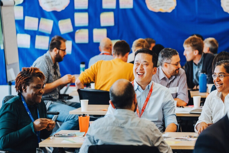 People happily workshopping and discussing at an event