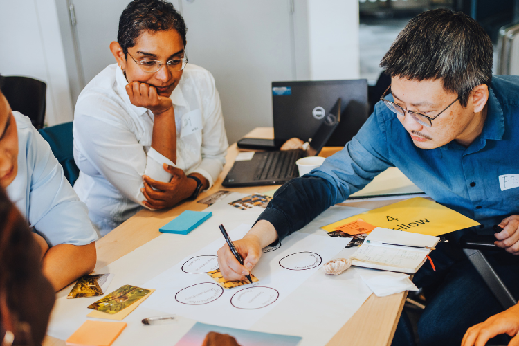 People collaborating and brainstorming ideas around a table