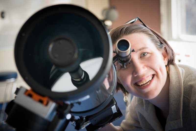 Imager of a researcher looking through a telescope