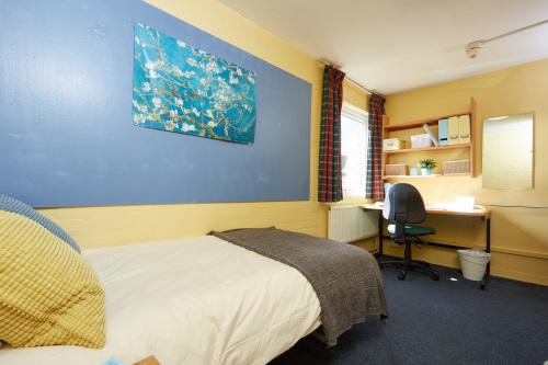 Whitefields bedroom Bedroom with bed, desk and chair, wall storage and window