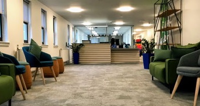 Image of green chairs in the wellbeing support waiting area