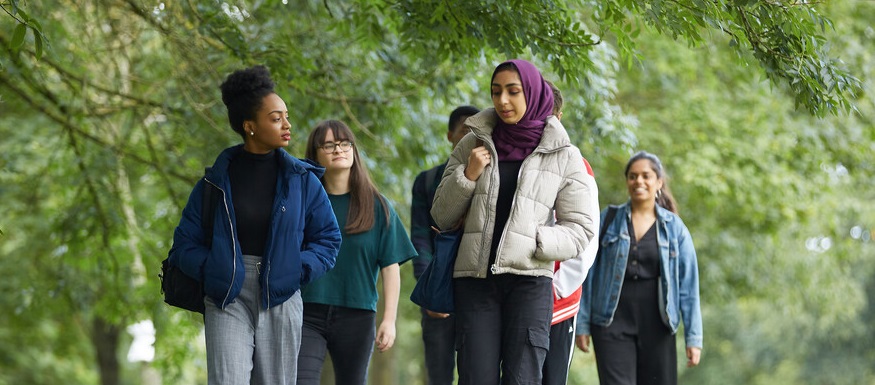 A group of students walking in a park