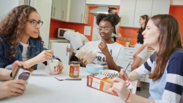 A group of students sitting at a table in shared accommodation