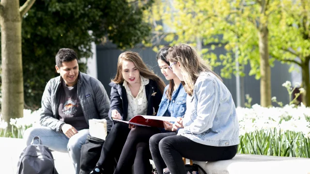 Students looking at a prospectus