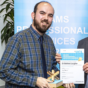 Photo of Matthew Laugher receiving an award and certificate