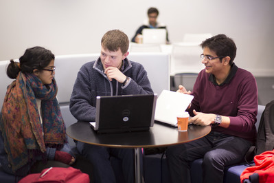 A group of 3 students in discussion