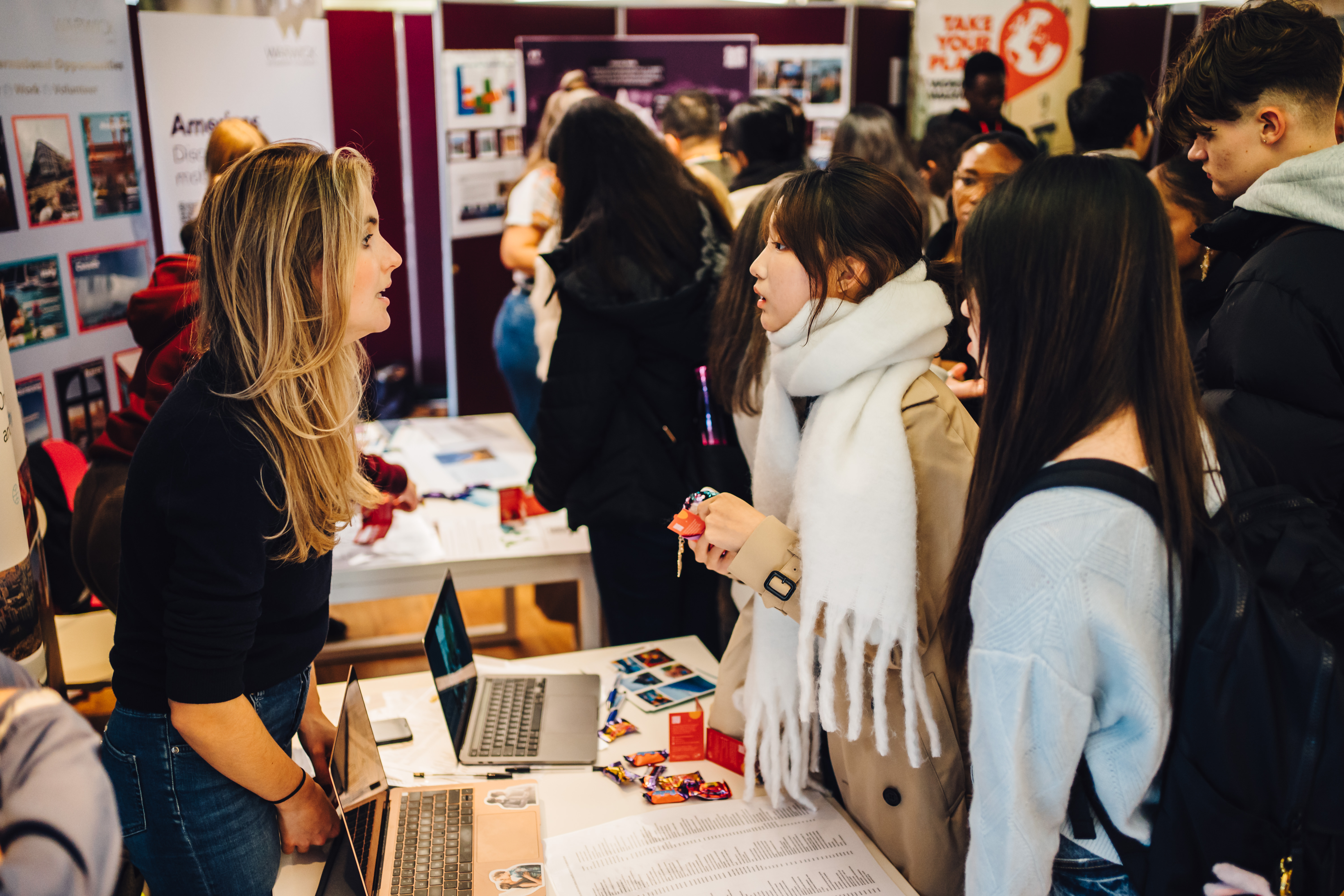 Students talking to stall holders at an event