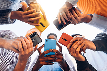 A group of people using their mobile phones