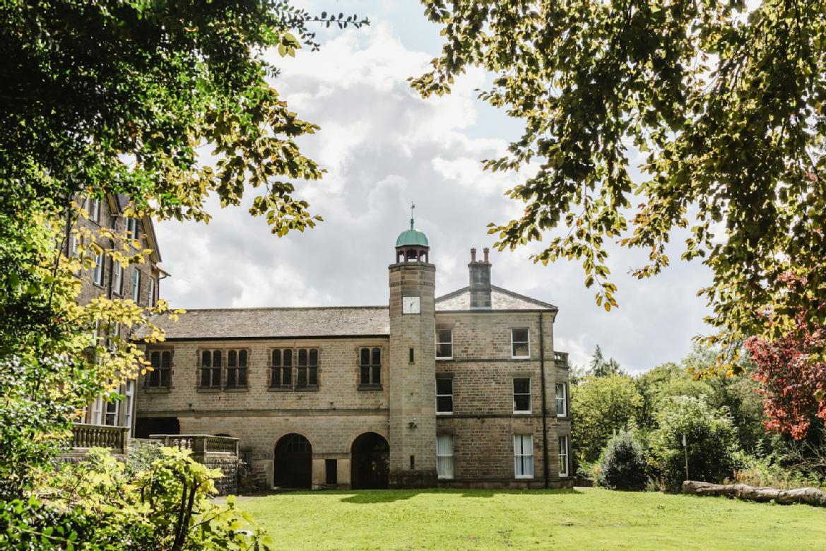 A picture of Cliff College chapel with a lawned courtyard in front of it.