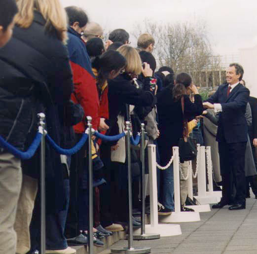 Prime Minister Tony Blair meets the crowd gathered outside the Arts Centre