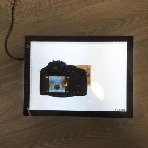 Caption: Using a camera and a light box to identity the note  Credit: University of Warwick