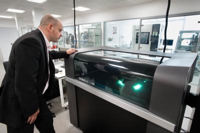 Professor Mark Williams of WMG, University of Warwick looking at the 3D printer