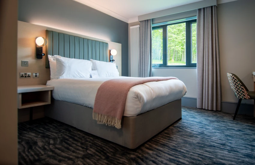 Large en-suite bed and breakfast accommodation at Scarman Large double bed in an en-suite bedroom with large window.