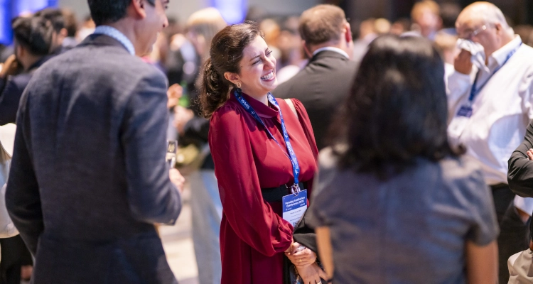 A group of conference guests laughing