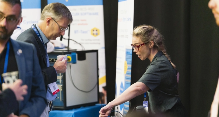A person talking with a conference attendee taking face to face