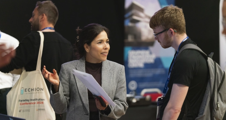 Two people taking during a conference