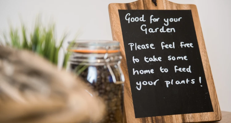 Image of a sign saying Good for your garden. Please feel free to take some home to feed your plants!