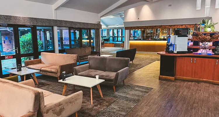 Lounge area with lots of comfy seating and drinks service machine