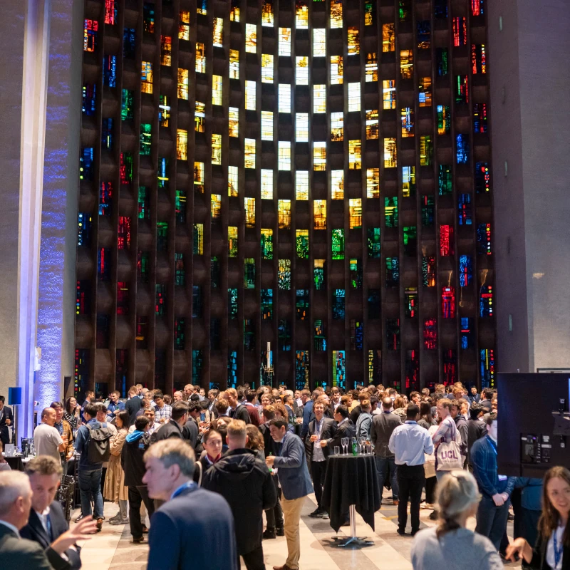 An image showcasing Coventry Cathedral's beautiful stain glass windows as a backdrop to one of Warwick Conference's events in this iconic location.