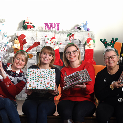 Pictured with wrapped Christmas presents at Canley Community Centre are, from left to right, Emma Willis, Sarah Dietrich and Gail Tomlinson-Short, all from Warwick Conferences, and centre manager Anna-Marie Corbett.