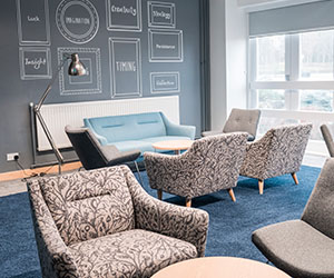 A range of comfy seating in a light, airy creative meeting room 